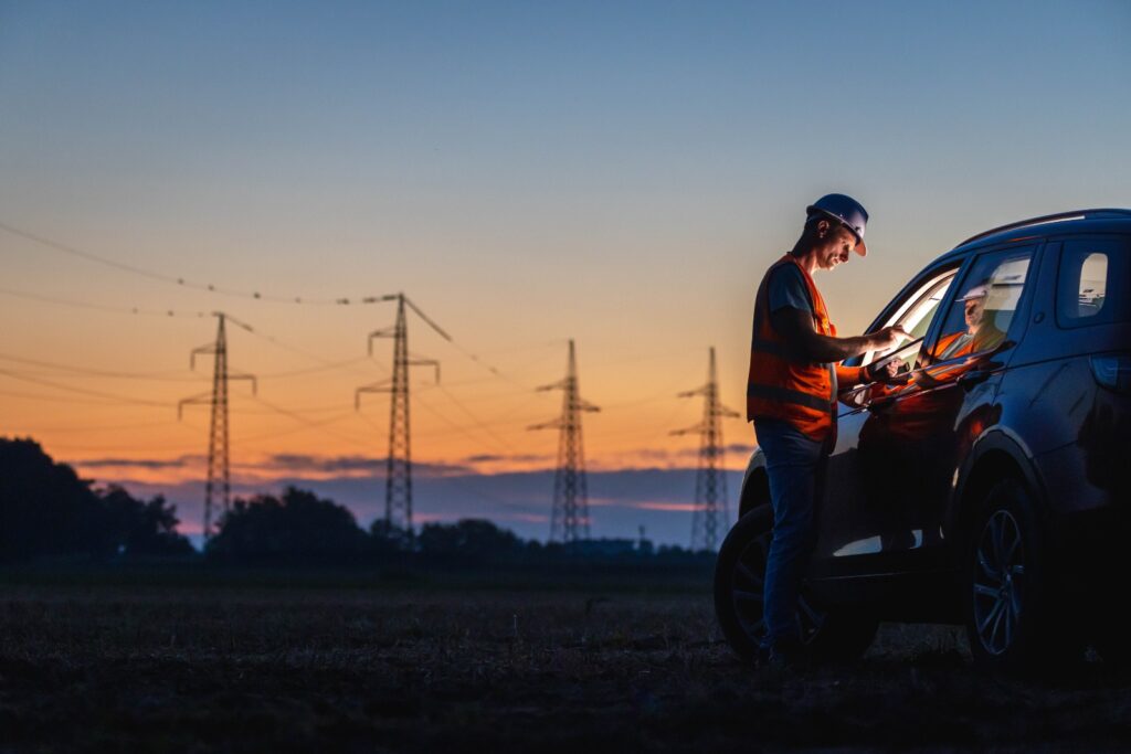 Surveyor with GNSS rover on open-cut mine bench